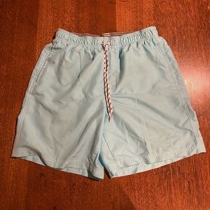 Swim trunks in cyan in a medium.